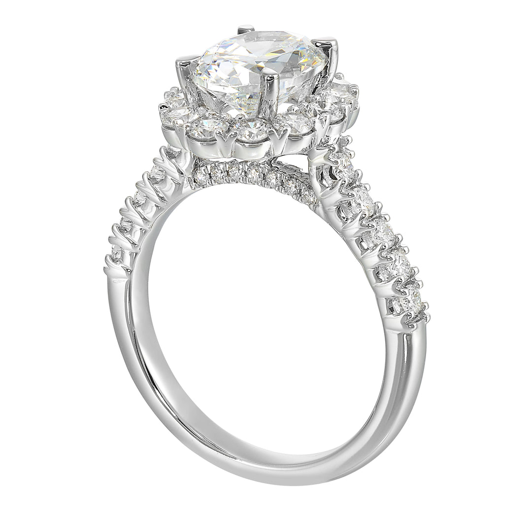 Featuring a mesmerizing floral halo around the solitaire diamond adorned with sparkling diamonds on the shank is perfect for the classic you.